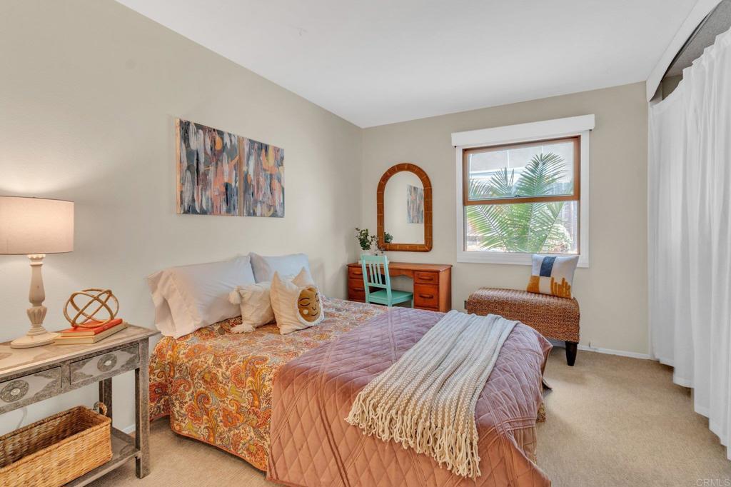 1528 Juniperhill Drive Encinitas, CA 92024 - Photo 26 of 40 a bedroom with a bed and a painting on the wall