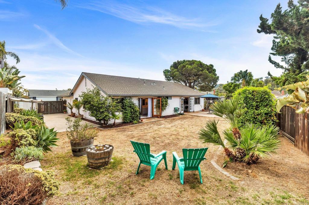 1528 Juniperhill Drive Encinitas, CA 92024 - Photo 29 of 40 a front view of a house with table and chairs potted plants