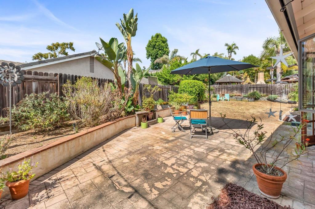 1528 Juniperhill Drive Encinitas, CA 92024 - Photo 34 of 40 a view of a porch with furniture and floor to ceiling window