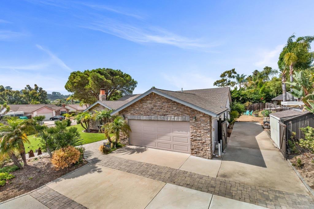1528 Juniperhill Drive Encinitas, CA 92024 - Photo 5 of 40 a front view of a house with a yard and garage