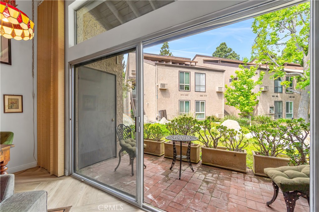 7890 East Spring Street, Unit 14A Long Beach, CA 90815 - Photo 18 of 43 a view of a porch with chairs and potted plants