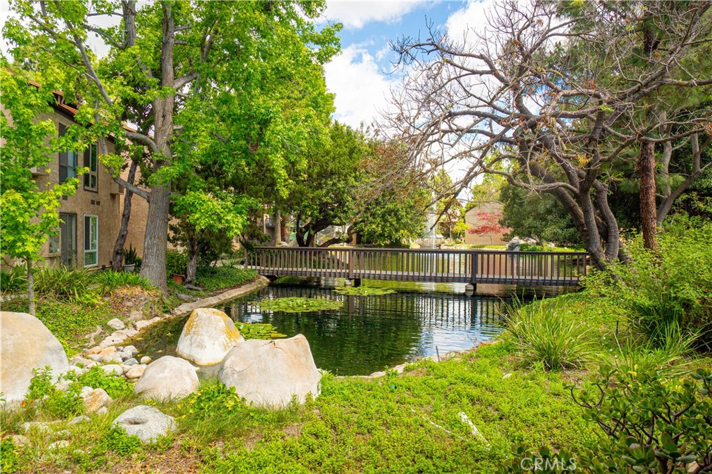 7890 East Spring Street, Unit 14A Long Beach, CA 90815 - Photo 25 of 43 a view of a lake with a house in the background