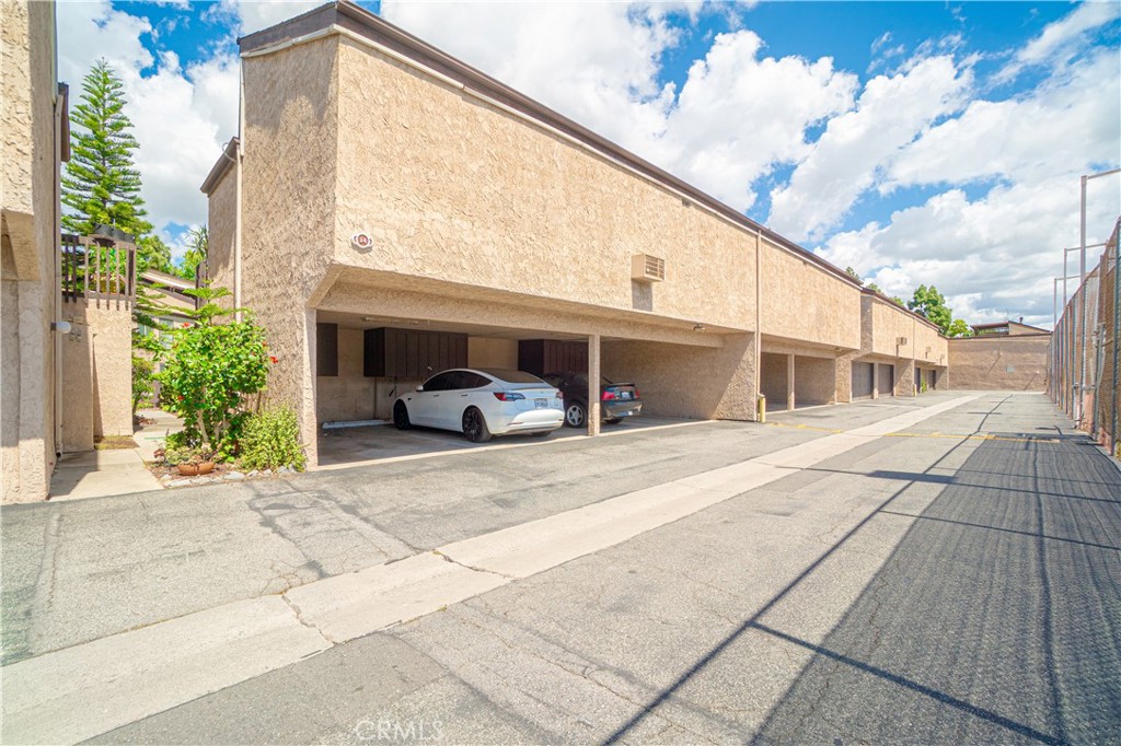 7890 East Spring Street, Unit 14A Long Beach, CA 90815 - Photo 27 of 43 a front view of a building with car parked