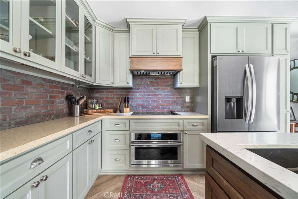 7890 East Spring Street, Unit 14A Long Beach, CA 90815 - Photo 3 of 43 a kitchen with stainless steel appliances granite countertop a refrigerator sink and stove