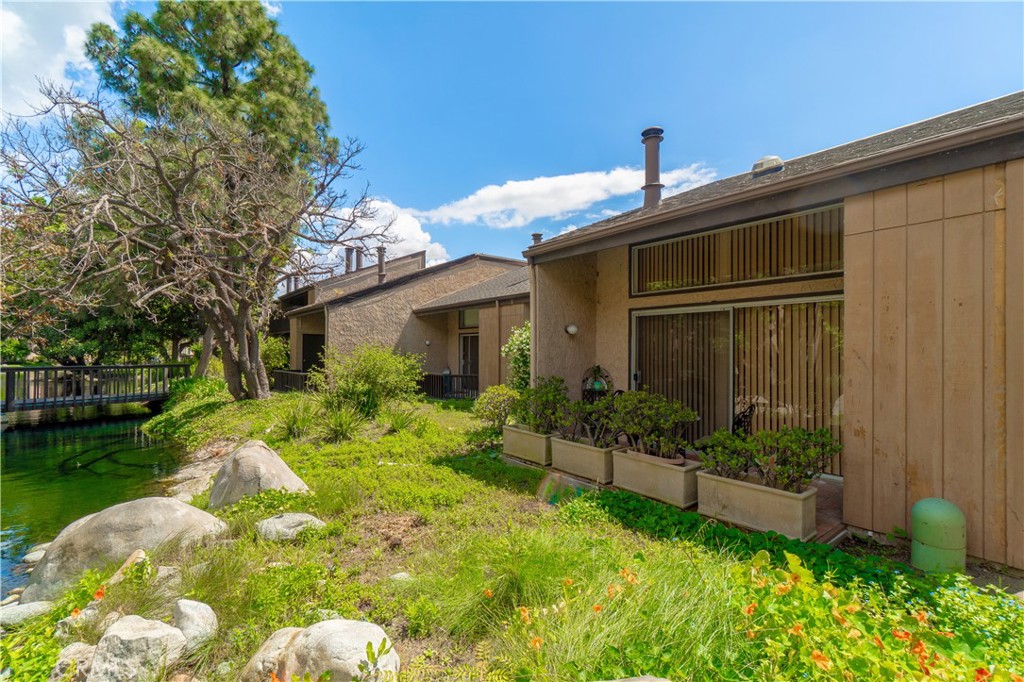7890 East Spring Street, Unit 14A Long Beach, CA 90815 - Photo 31 of 43 a front view of a house with garden