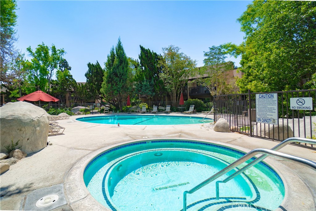 7890 East Spring Street, Unit 14A Long Beach, CA 90815 - Photo 34 of 43 a swimming pool with outdoor seating and yard