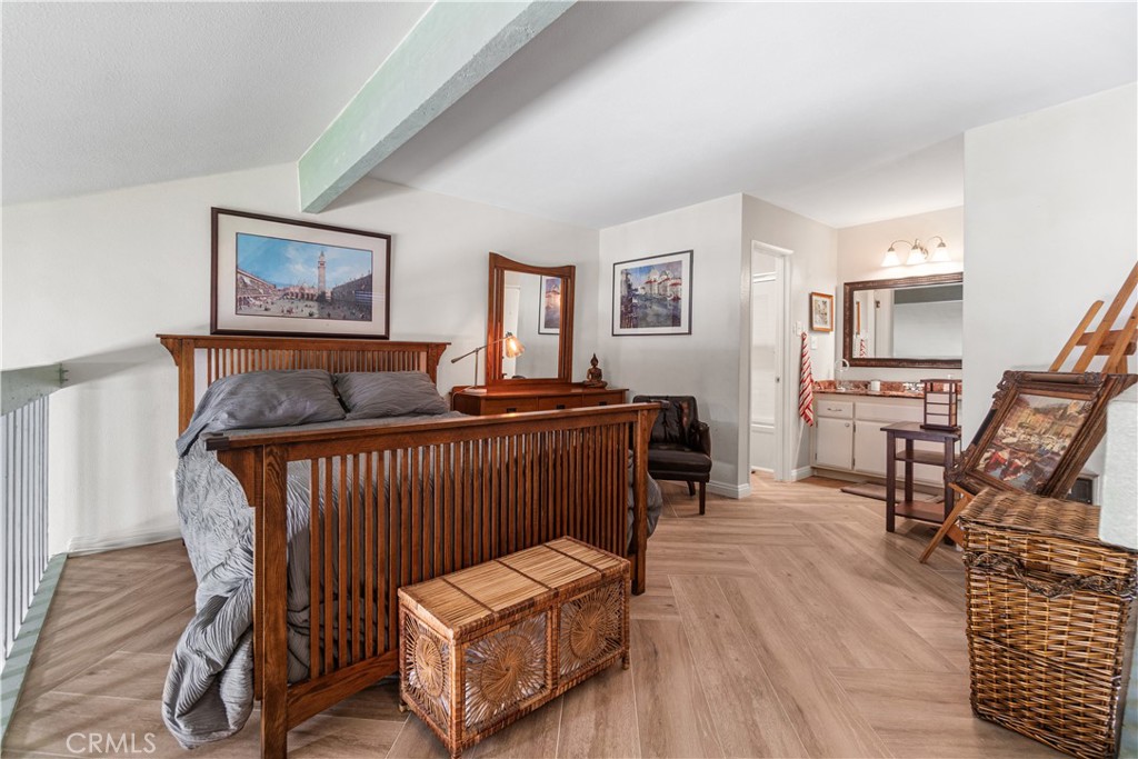 7890 East Spring Street, Unit 14A Long Beach, CA 90815 - Photo 6 of 43 a bedroom with furniture and a wooden floor