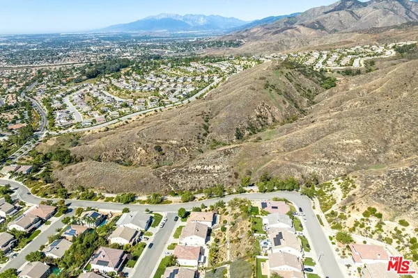 a view of a dry yard and mountain