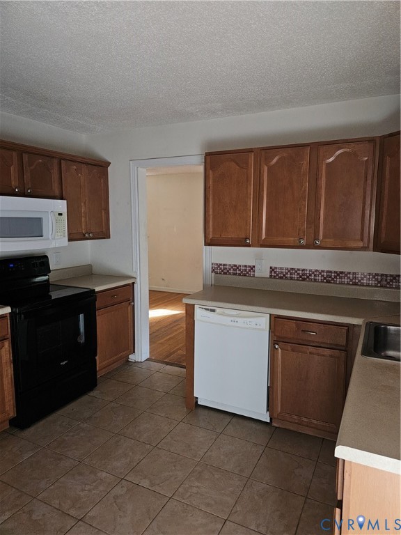 916 Brantley Road Richmond, VA 23235 - Photo 6 of 8 Kitchen with stove, dishwasher, light countertops,