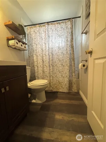 a bathroom with a toilet and a shower