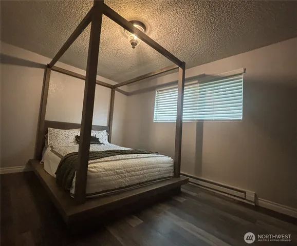 a bed sitting in a bedroom next to a window