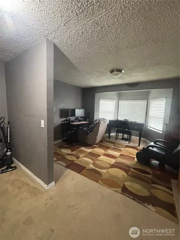 a view of a livingroom with furniture and windows