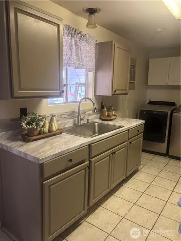 a kitchen with a sink and cabinets
