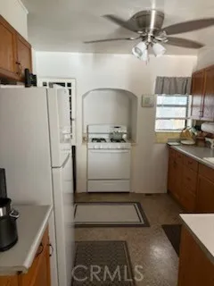 a kitchen with a refrigerator and a stove