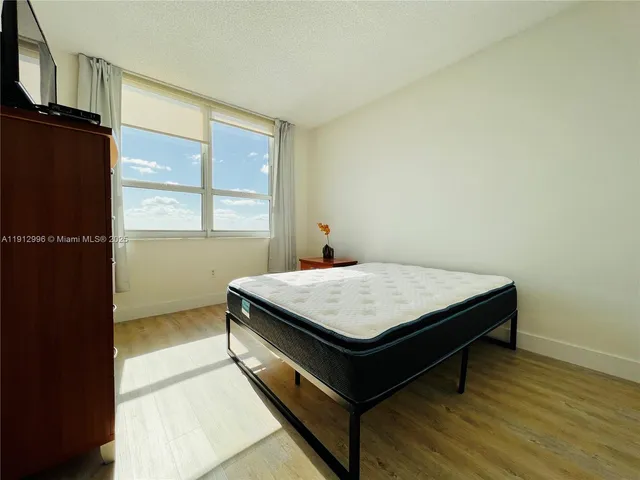 a room with pool table and windows