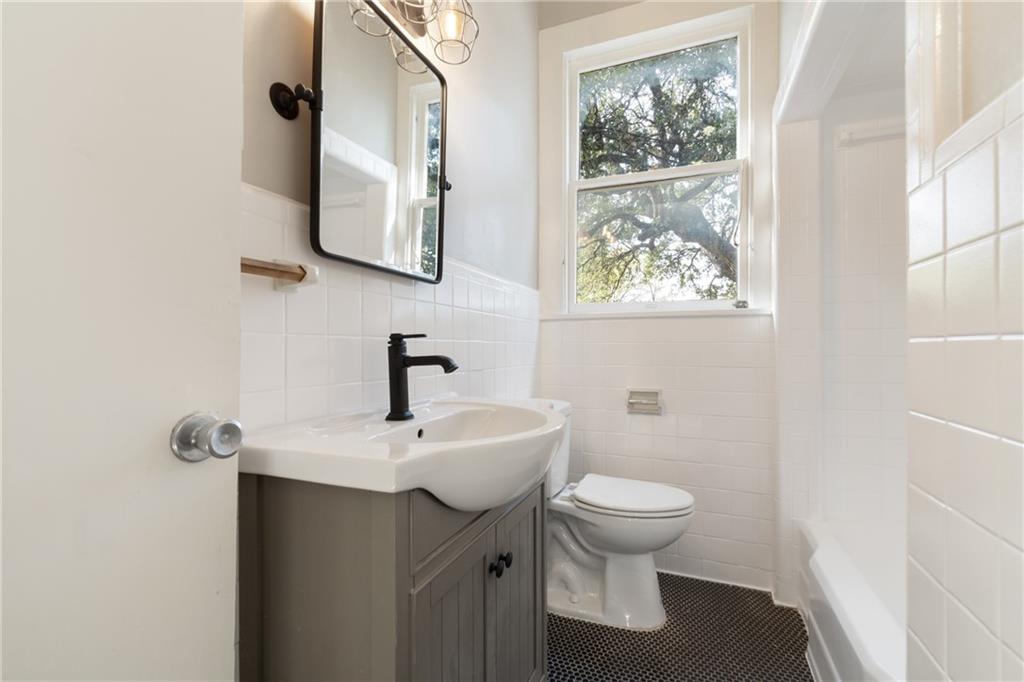 3210 Hampton Road, Unit A B C Austin, TX 78705 - Photo 29 of 42 Bathroom featuring a gray vanity with an integrated sink, matte black faucet, and a rectangular mirror with industrial-style lighting