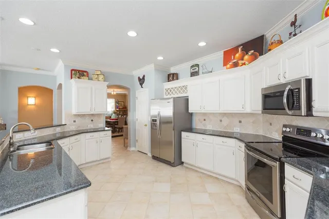 a kitchen with a sink stove oven and microwave