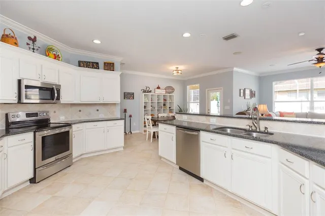 a view of a dining room with furniture and a potted plant