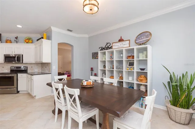 a living room with furniture and kitchen view