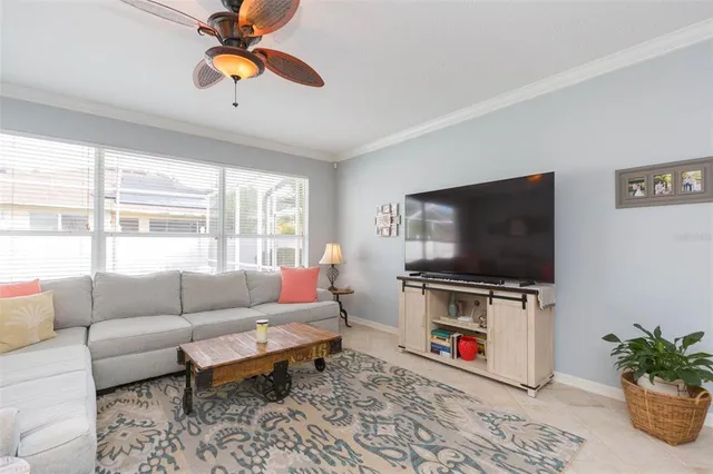 a bedroom with a large bed and ceiling fan