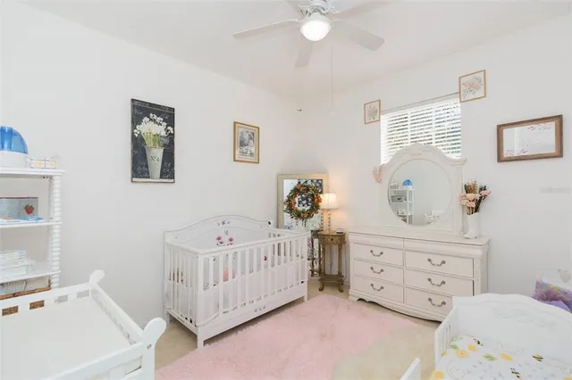 a bedroom with furniture and a flat screen tv