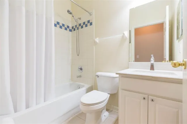 a soft toy sitting on a bed in a room