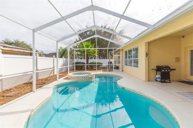 a living room with furniture large window and wooden floor