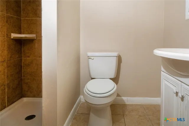 a bathroom with a toilet sink and vanity