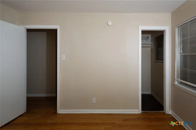 a view of wooden floor and brick walls
