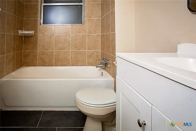 a bathroom with a sink toilet and a mirror