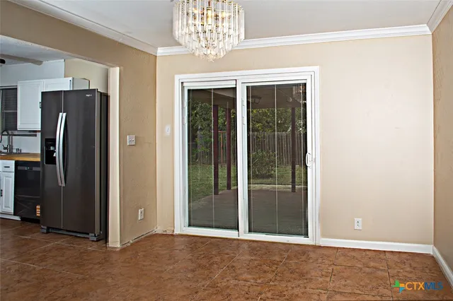 a kitchen with a refrigerator and a sink