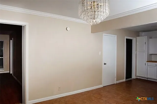 an empty room with closet and a ceiling fan