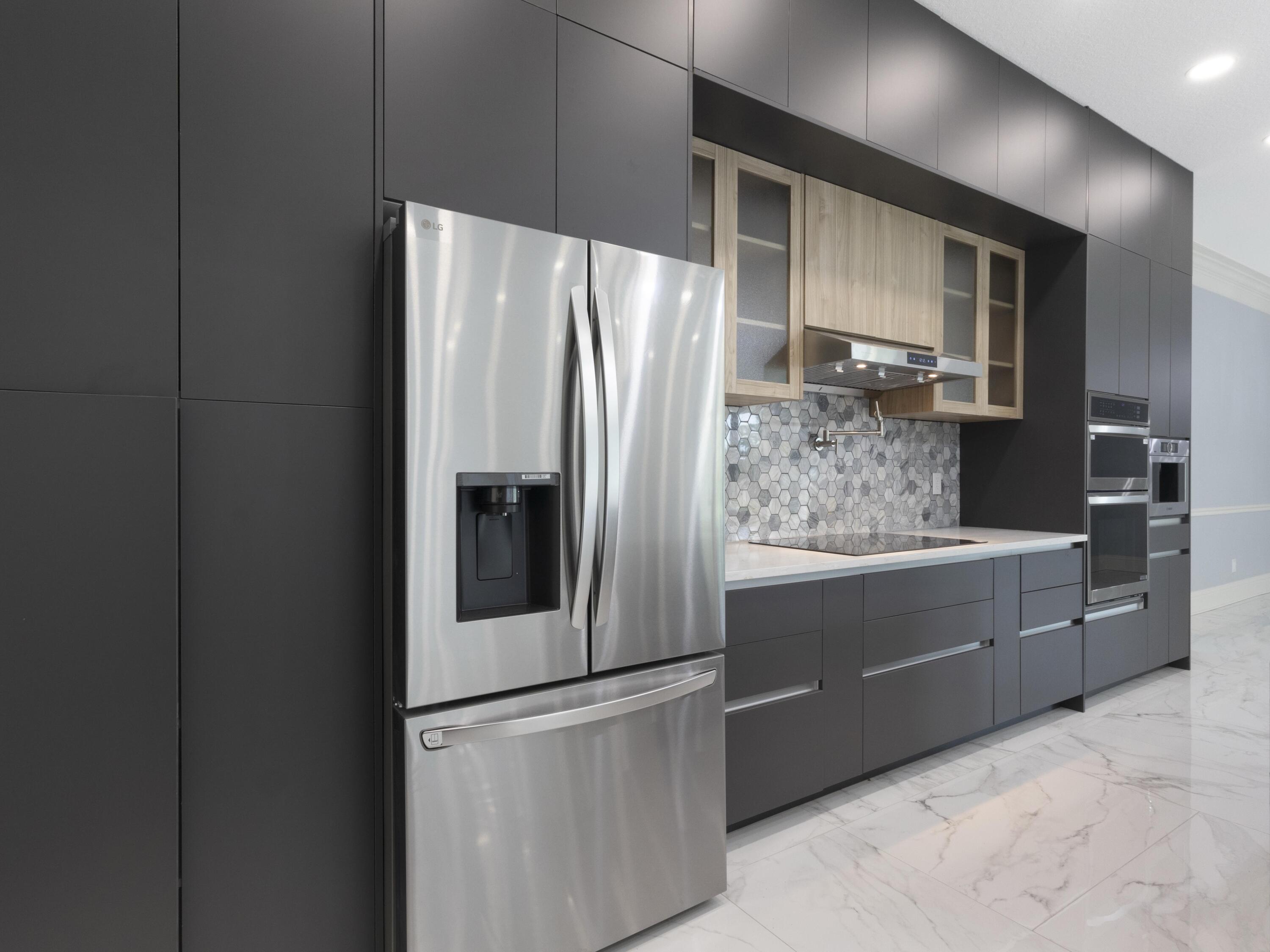 17436 71st Lane North Loxahatchee, FL 33470 - Photo 14 of 50 a kitchen with stainless steel appliances a refrigerator sink and cabinets