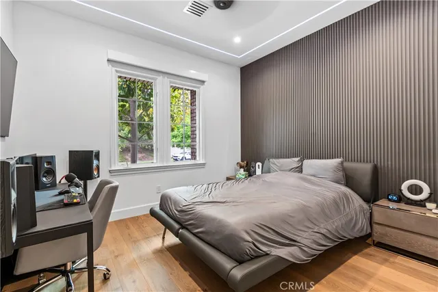 a bedroom with a bed and a desk