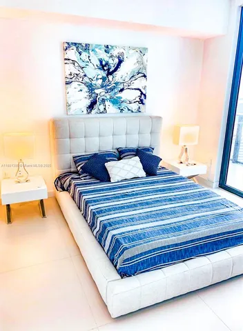 a bedroom with a bed and a night stand