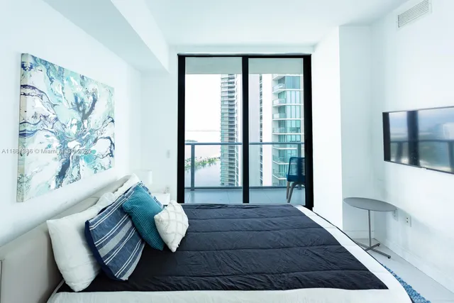 a living room with furniture and a floor to ceiling window