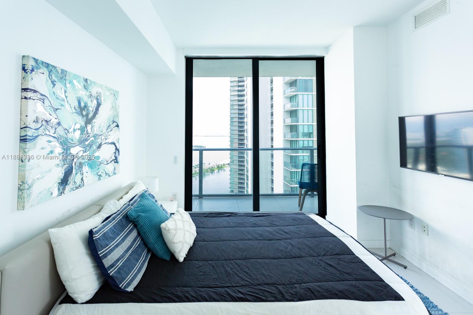 501 Northeast 31st Street, Unit 3906 Miami, FL 33137 - Photo 13 of 32 a living room with furniture and a floor to ceiling window