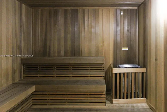 a living room with patio furniture and a potted plant