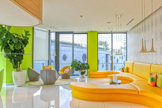 a living room with furniture and a floor to ceiling window