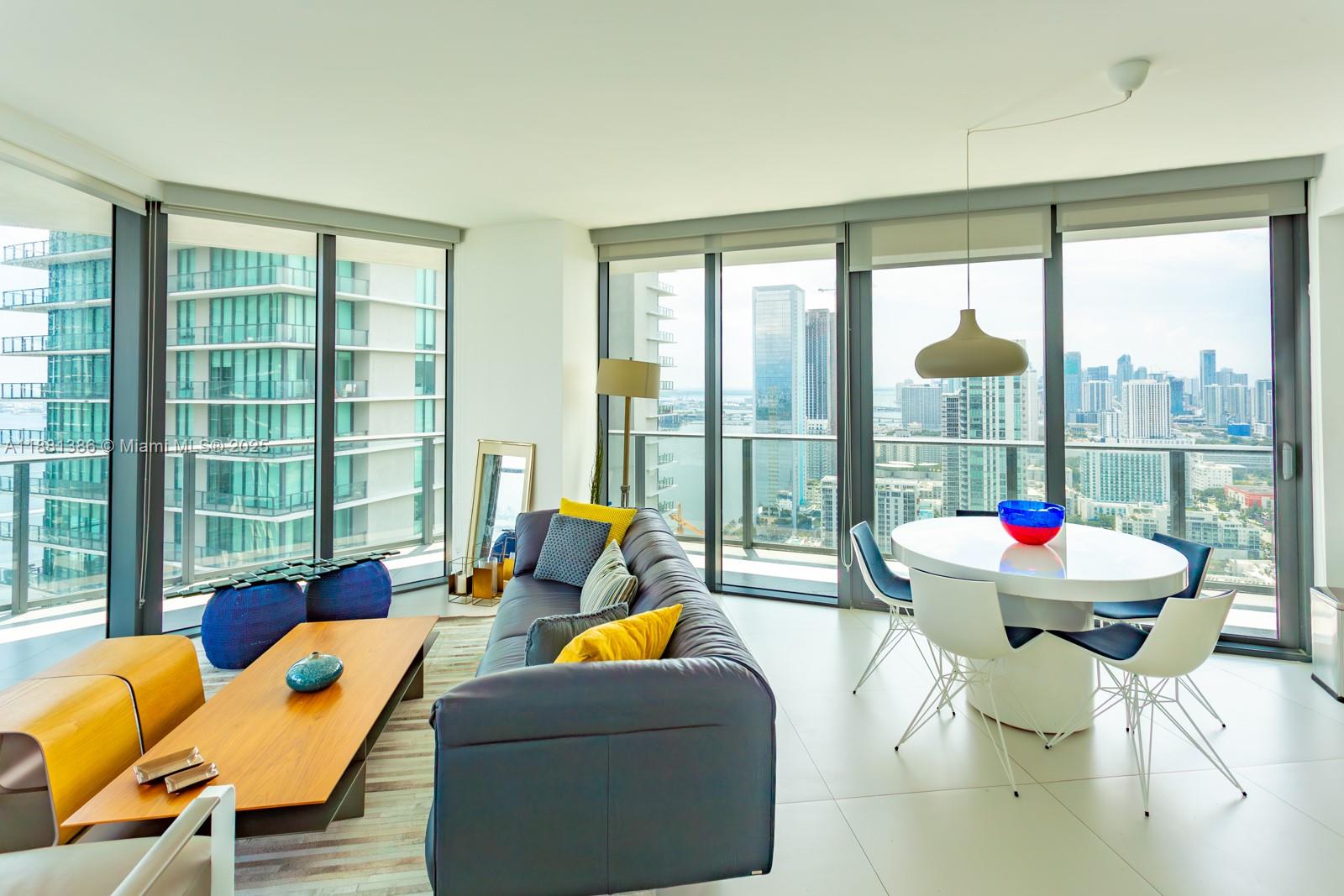 501 Northeast 31st Street, Unit 3906 Miami, FL 33137 - Photo 3 of 32 a living room filled with furniture and floor to ceiling windows