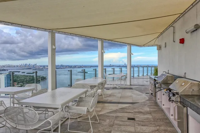 a view of a patio with a table and chairs
