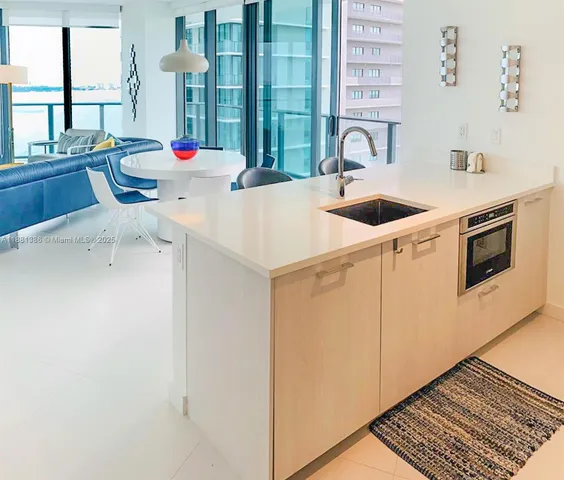 a kitchen with stainless steel appliances a sink a stove and a refrigerator