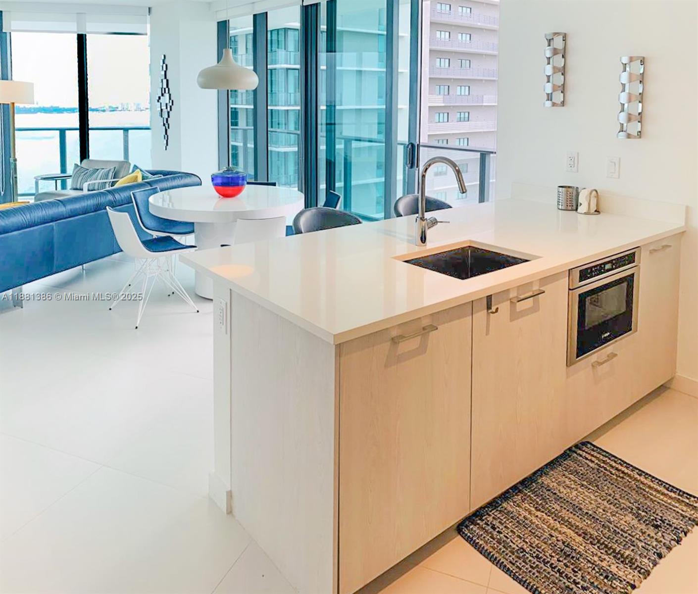 501 Northeast 31st Street, Unit 3906 Miami, FL 33137 - Photo 4 of 32 a kitchen with stainless steel appliances a sink a stove and a refrigerator