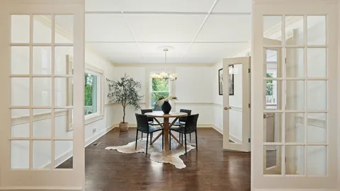 a view of a dining room with furniture wooden floor and chandelier