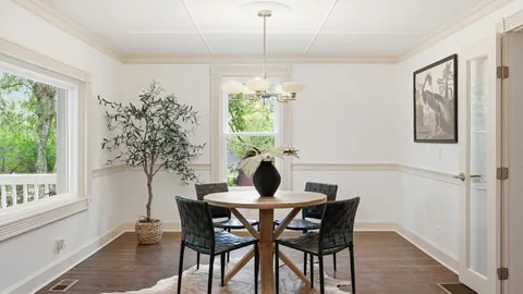 a kitchen with kitchen island granite countertop a sink cabinets stainless steel appliances and a large window