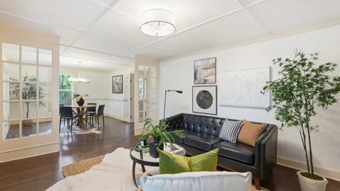 a dining room with furniture and wooden floor