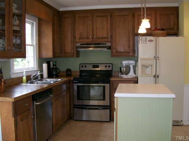 6305 Wynbrook Way Raleigh, NC 27612 - Photo 4 of 12 Sunny kitchen with island, stainless steel dishwasher and stove, pantry.