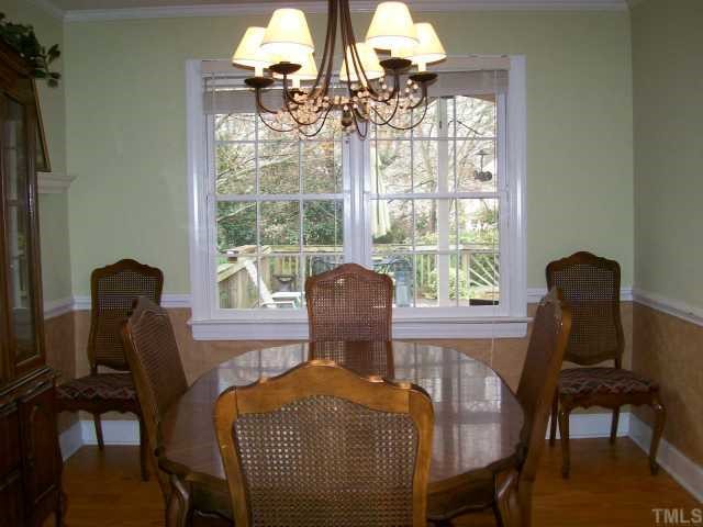 6305 Wynbrook Way Raleigh, NC 27612 - Photo 5 of 12 Formal dining room with hardwood floor, crown molding and chair rail. . Perfect for enjoying those holiday dinners!
