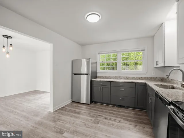 a kitchen with a sink cabinets and stainless steel appliances