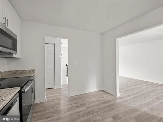 a view of a kitchen with a sink wooden floor and staircase